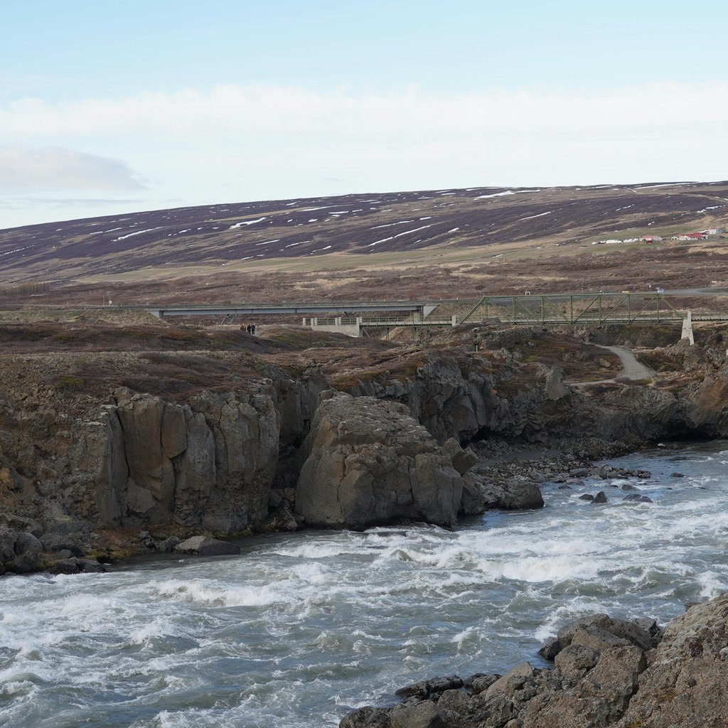 A picturesque view of a rugged river landscape in Akureyri, Iceland during spring.