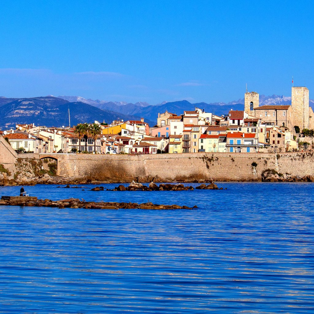 Explore the picturesque view of Antibes with vibrant buildings by the sea in Provence, France.
