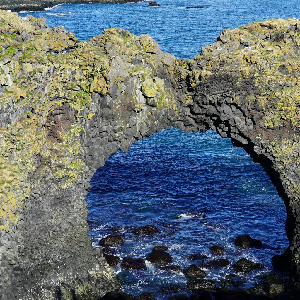 Explore the stunning natural arch at Arnarstapi along Iceland's breathtaking coast.