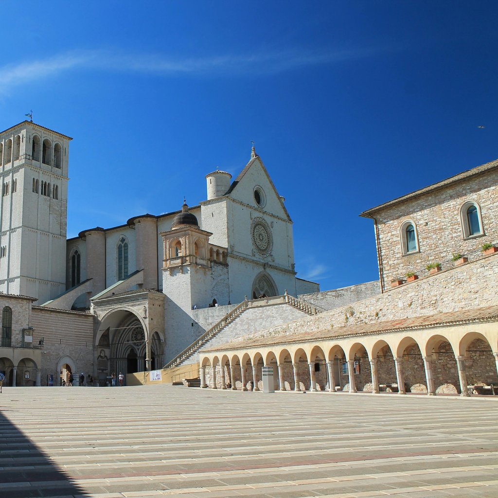 Scenic view of the Basilica of Saint Francis in Assisi with clear blue skies.