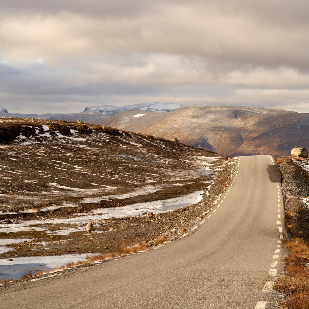 Explore a winding road through the picturesque Aurlandsvangen landscape, capturing late autumn beauty.