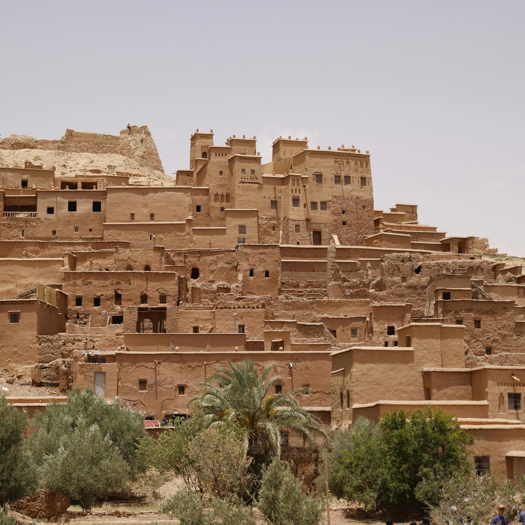 Explore the ancient architecture of Ait Benhaddou village in Morocco's arid landscape.