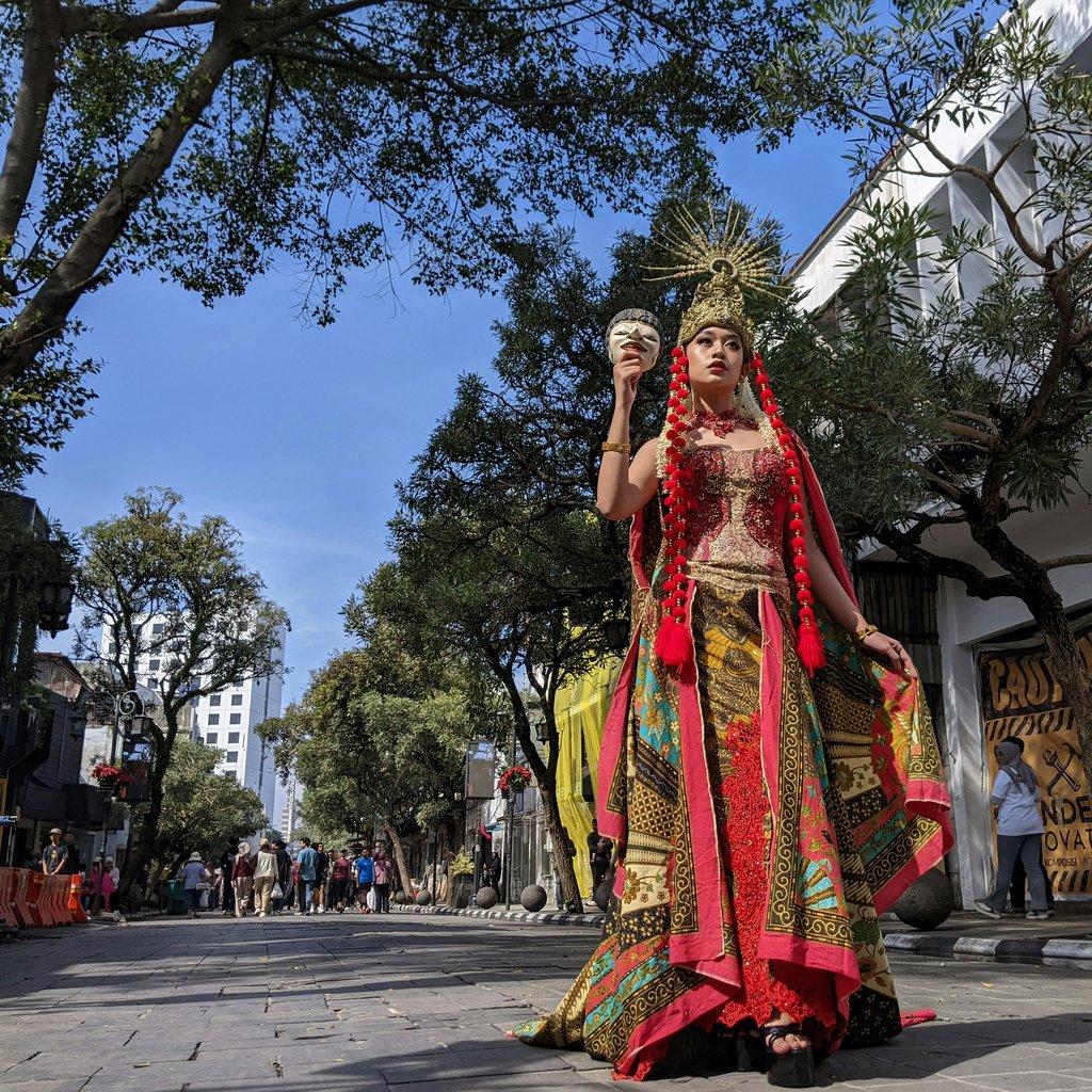 Colorful traditional costume in a cultural parade on Asia-Africa Street, Bandung, Indonesia.