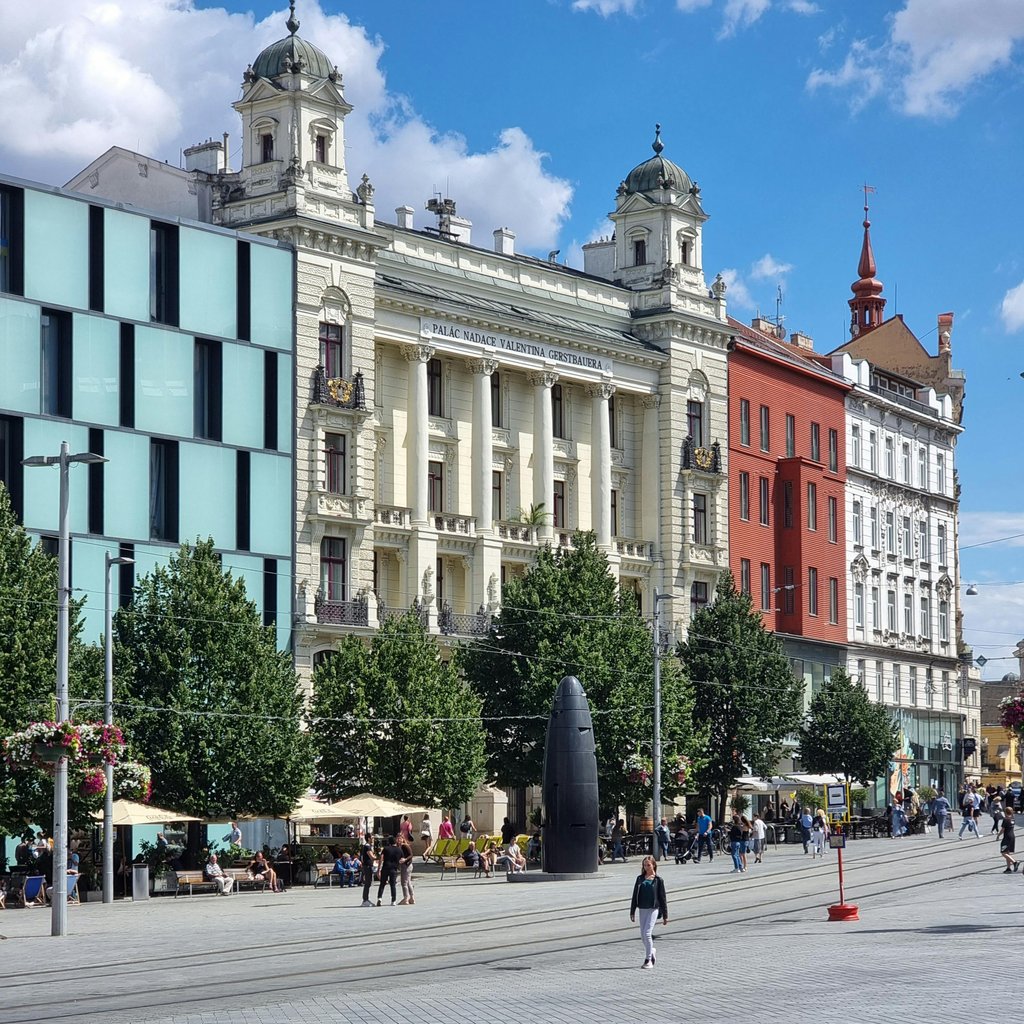 A lively scene at Náměstí Svobody in Brno, showcasing historic architecture and city life.