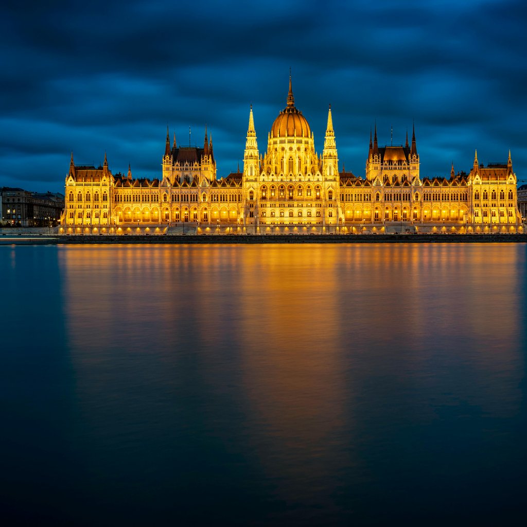 Stunning view of the Hungarian Parliament Building in Budapest glowing against the night sky.