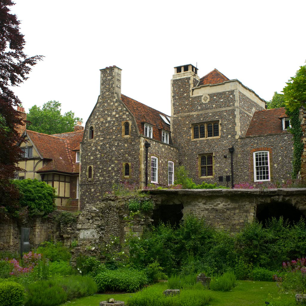 Charming view of historic architecture and lush gardens in Canterbury, England.