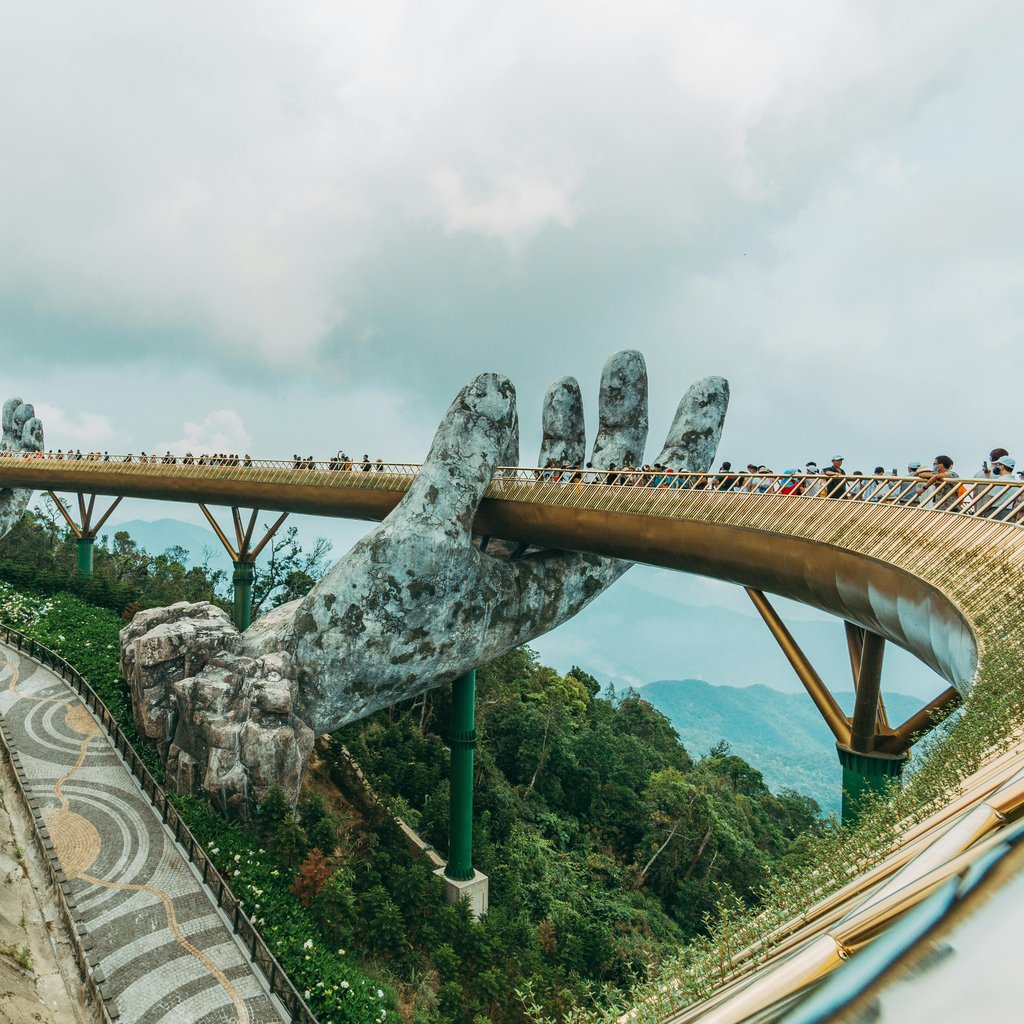 Iconic Golden Bridge with giant hands in Ba Na Hills, a tourist attraction in Vietnam.