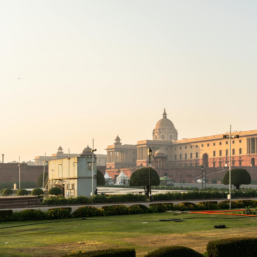 Stunning view of Rashtrapati Bhavan with a clear sky in New Delhi, India, during sunrise.