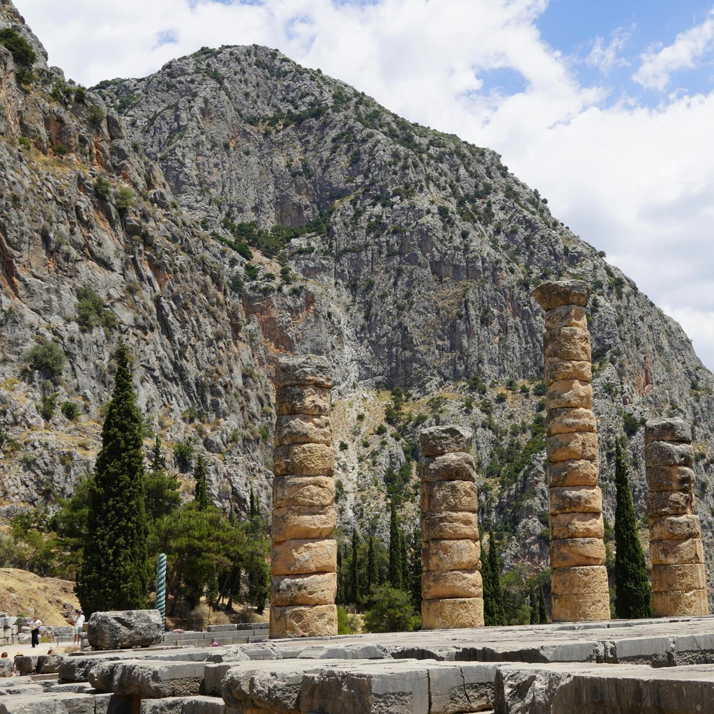 Capture of ancient temple columns at Delphi, Greece, under a bright sky.