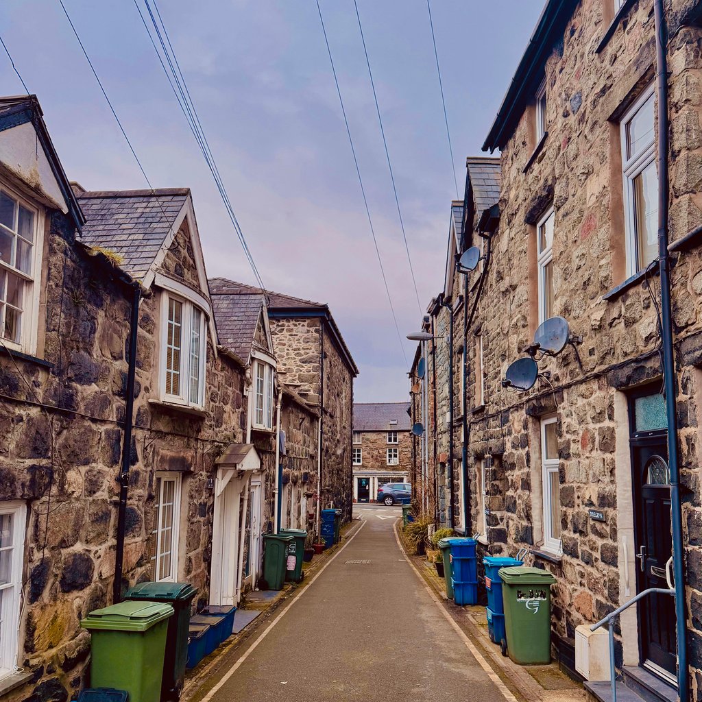 Historic stone houses line a quaint alley in Dolgellau, capturing the essence of Welsh architecture.