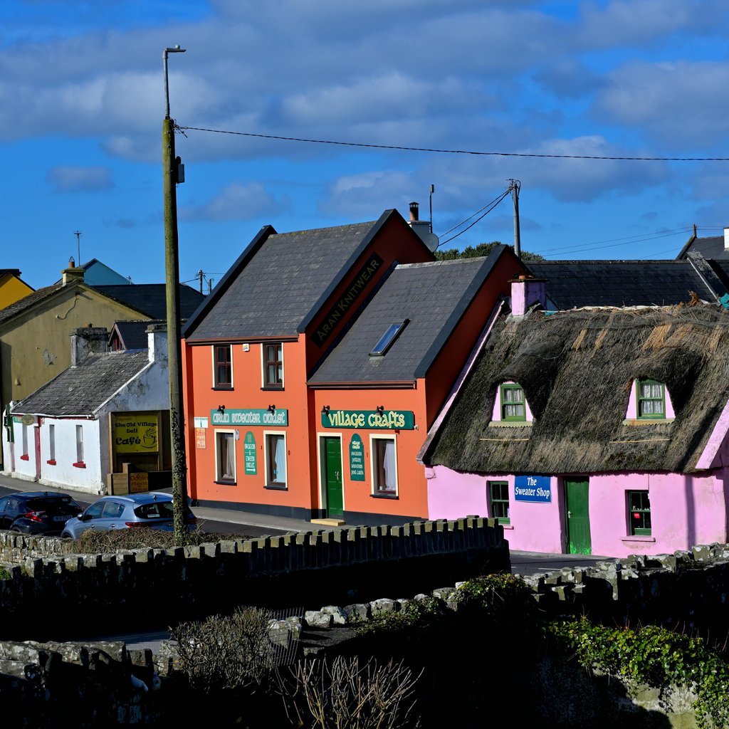 Charming colorful buildings along a vibrant street in Doolin, Ireland.