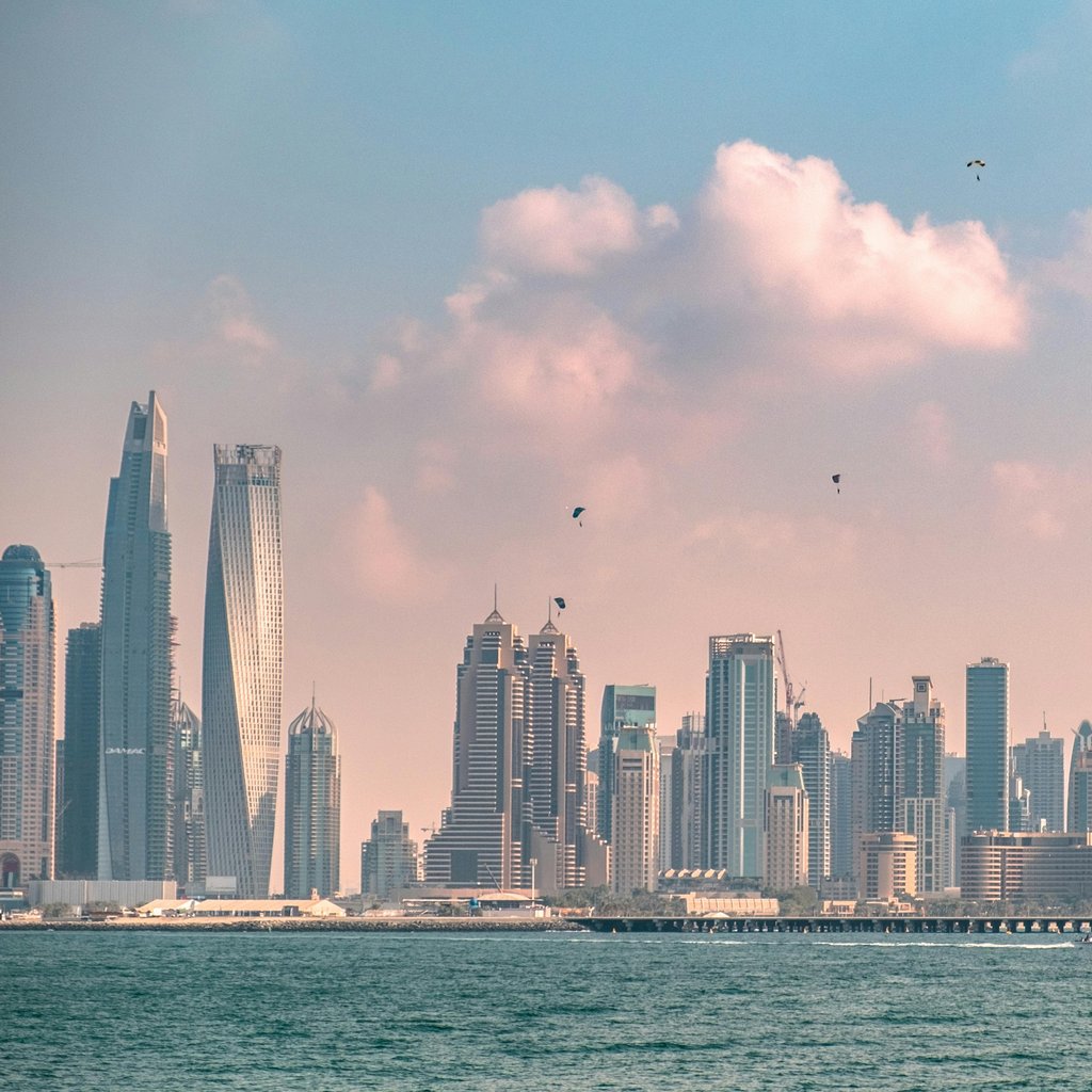 Breathtaking view of Dubai's modern skyline against a cloudy sky, showcasing its iconic architecture.