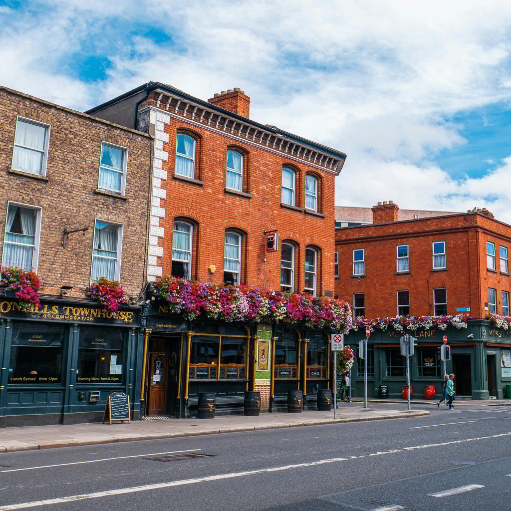 Vibrant scene of historic buildings and street life in Dublin, Ireland.