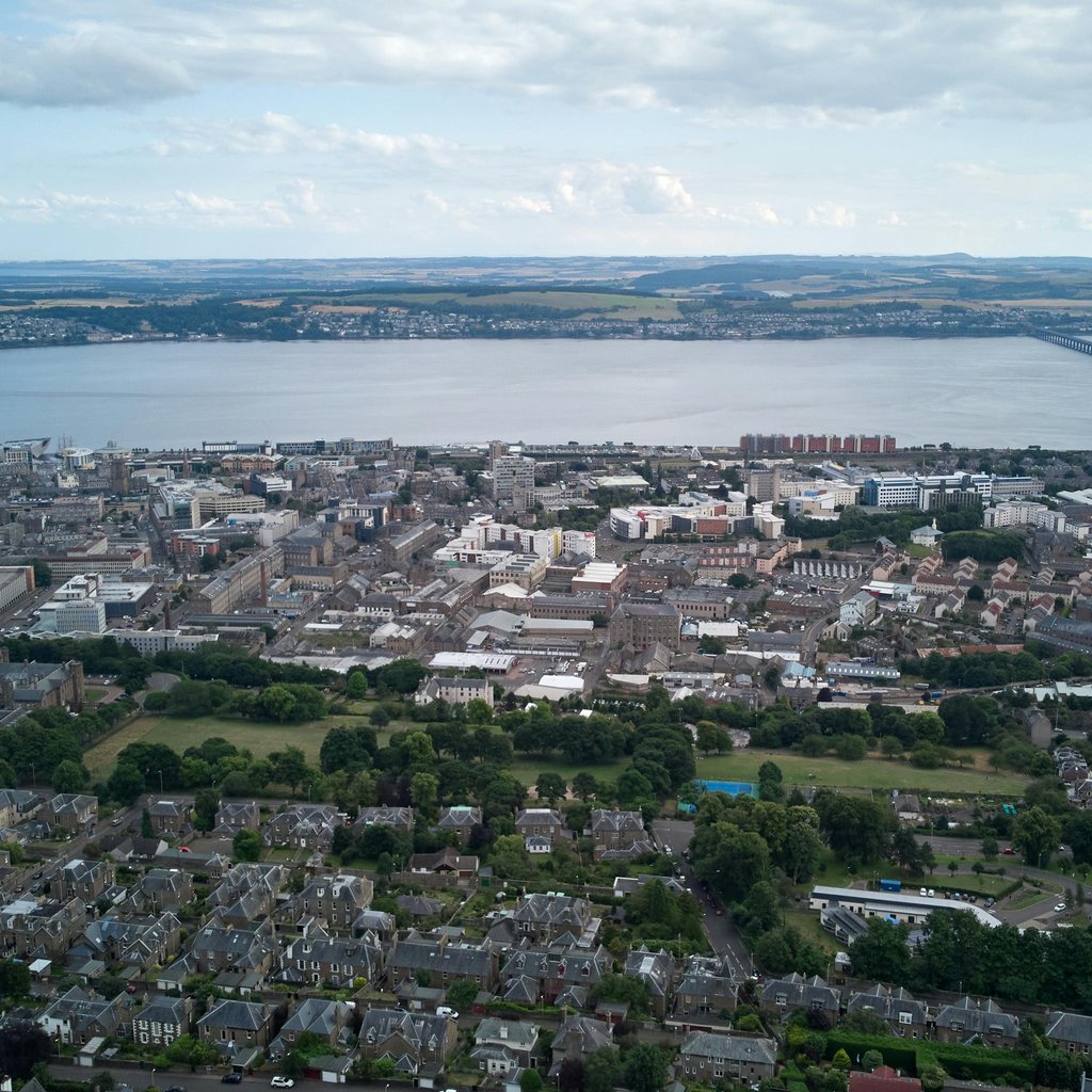 Stunning aerial view capturing Dundee cityscape and iconic Tay Bridge in Scotland.