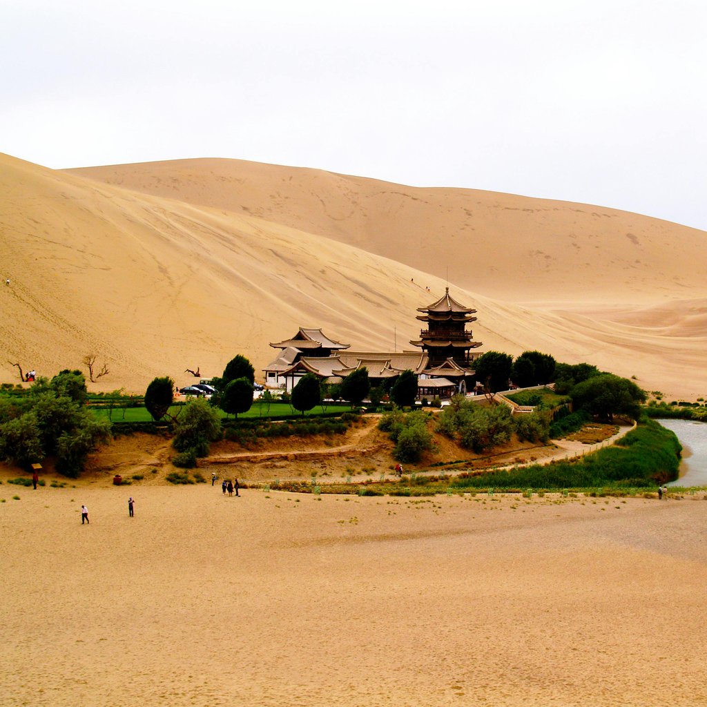 A stunning vista of Crescent Lake surrounded by Mingsha Sand Dunes in Dunhuang, China.