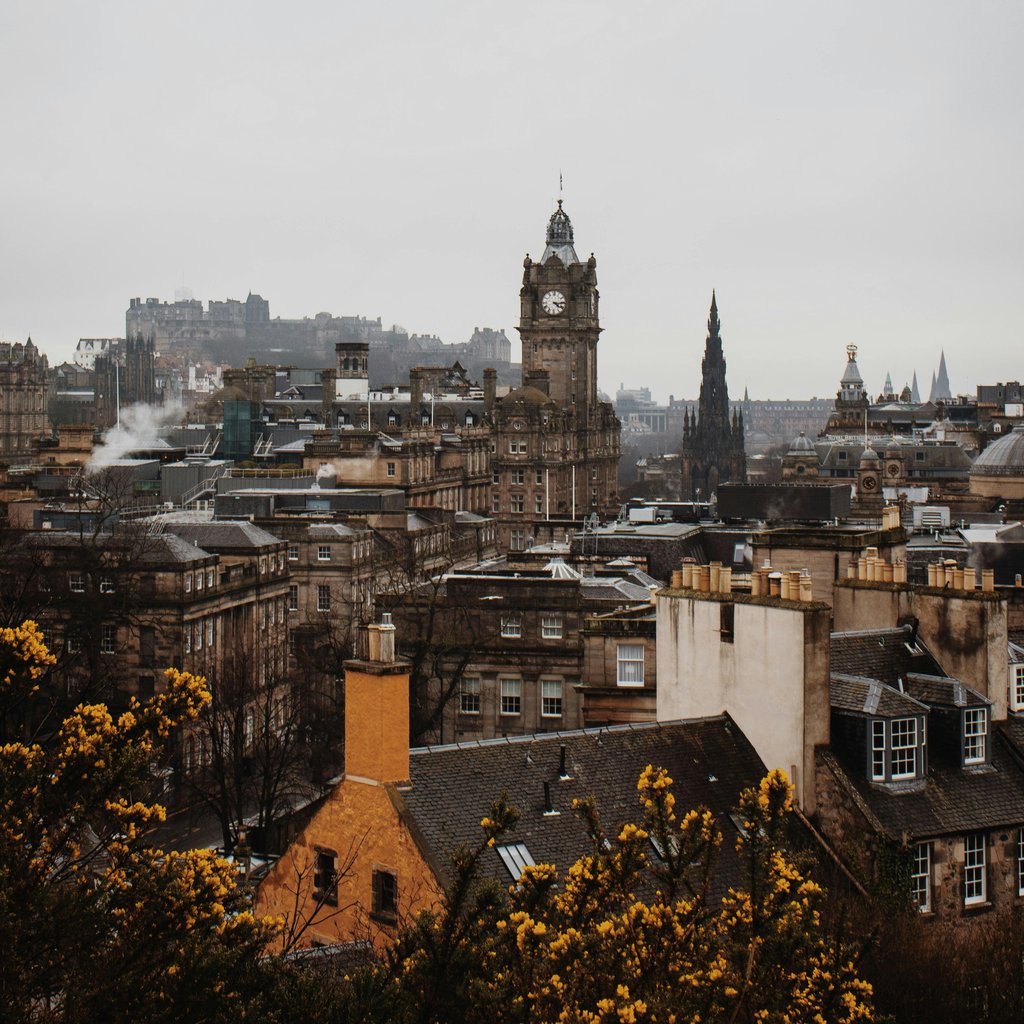 A stunning view of Edinburgh's skyline featuring the iconic Balmoral Clock Tower during fall.
