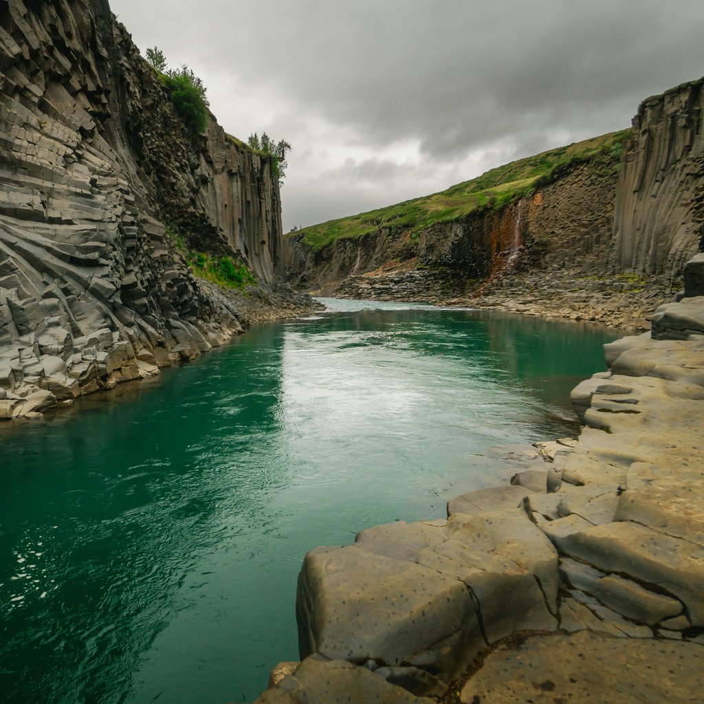 Explore the breathtaking basalt column canyon in Egilsstaðir, Iceland, showcasing nature's unique formations.