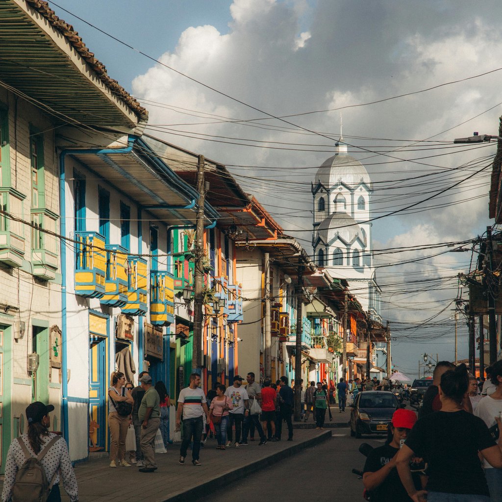 Vibrant street scene in Filandia, Colombia showcasing colorful architecture and bustling life.