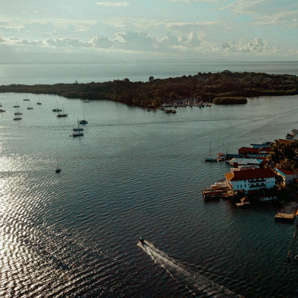 A breathtaking aerial view of a vibrant island town with a bustling harbor and scenic waterfront.