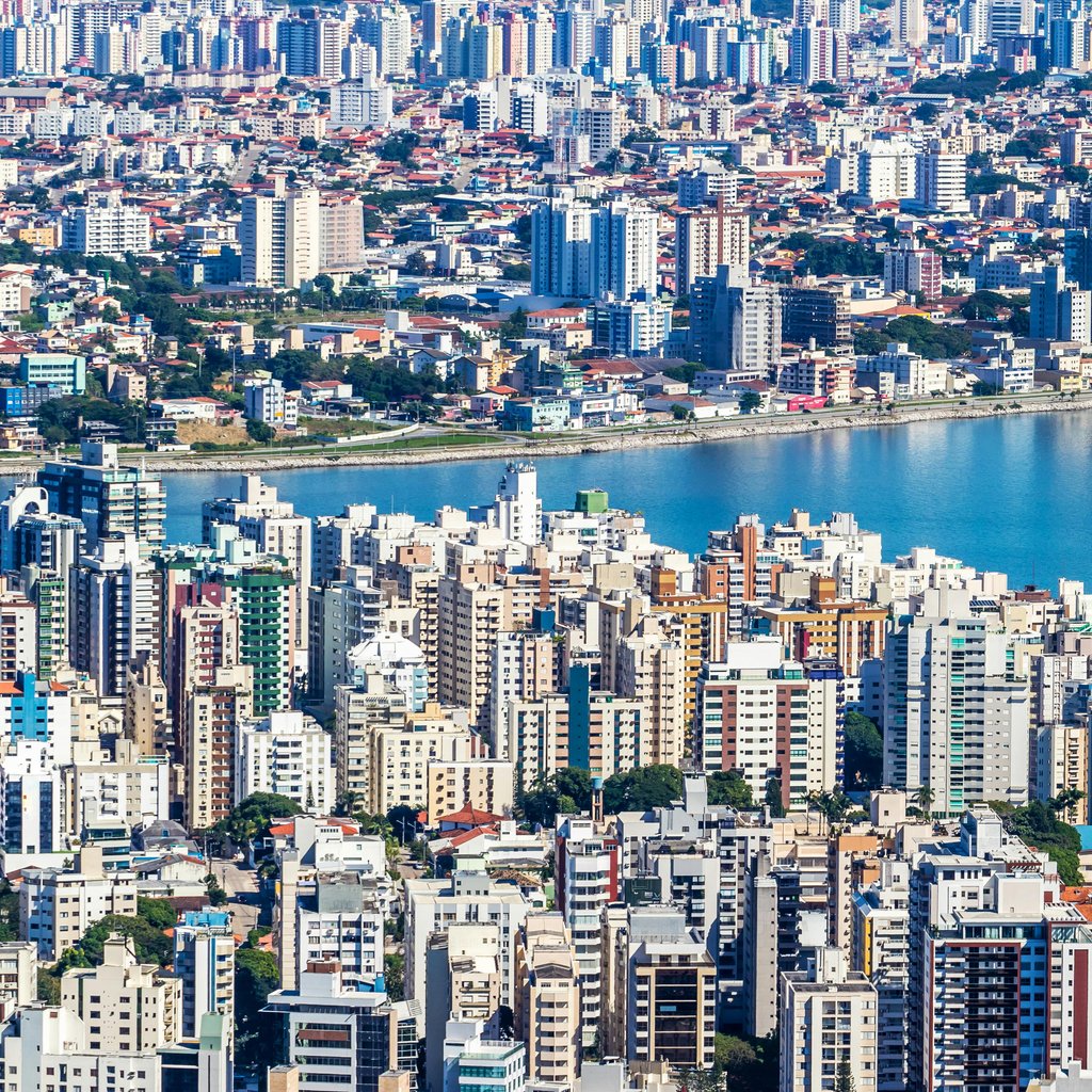 Dynamic aerial view of Florianópolis, Brazil showcasing urban waterfront and vibrant cityscape.