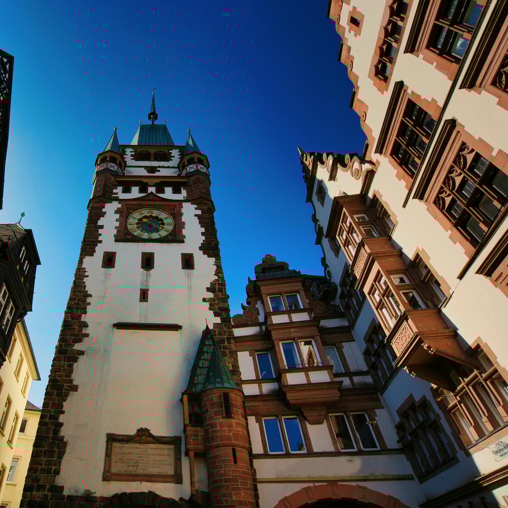 Afternoon view of the historic clock tower in Freiburg, Germany, showcasing medieval architecture.