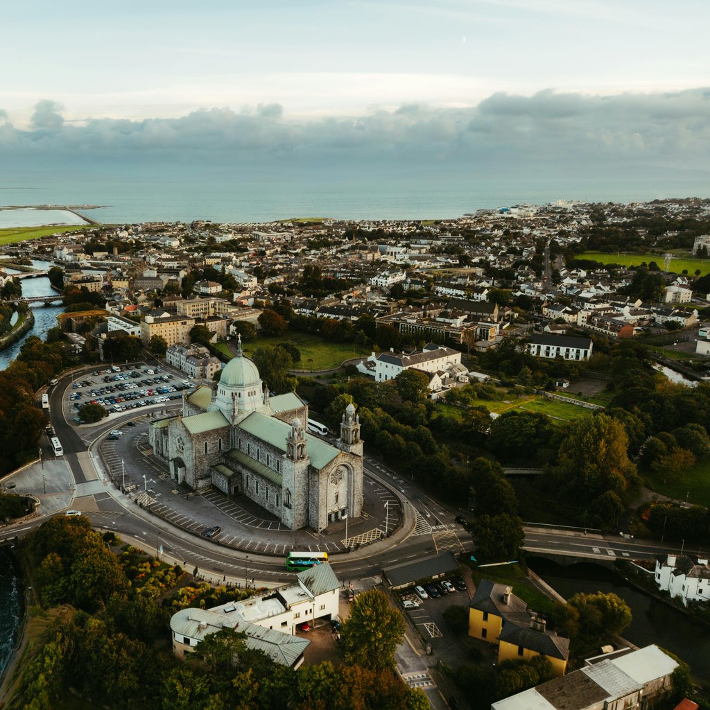 A breathtaking aerial view of Galway, Ireland featuring St. Nicholas' Cathedral and surrounding landscape.