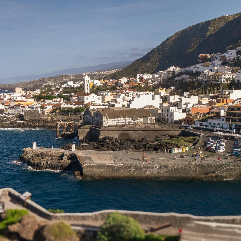 Aerial view of Garachico town along the rugged coastline of Tenerife, Spain, showcasing its charming architecture.