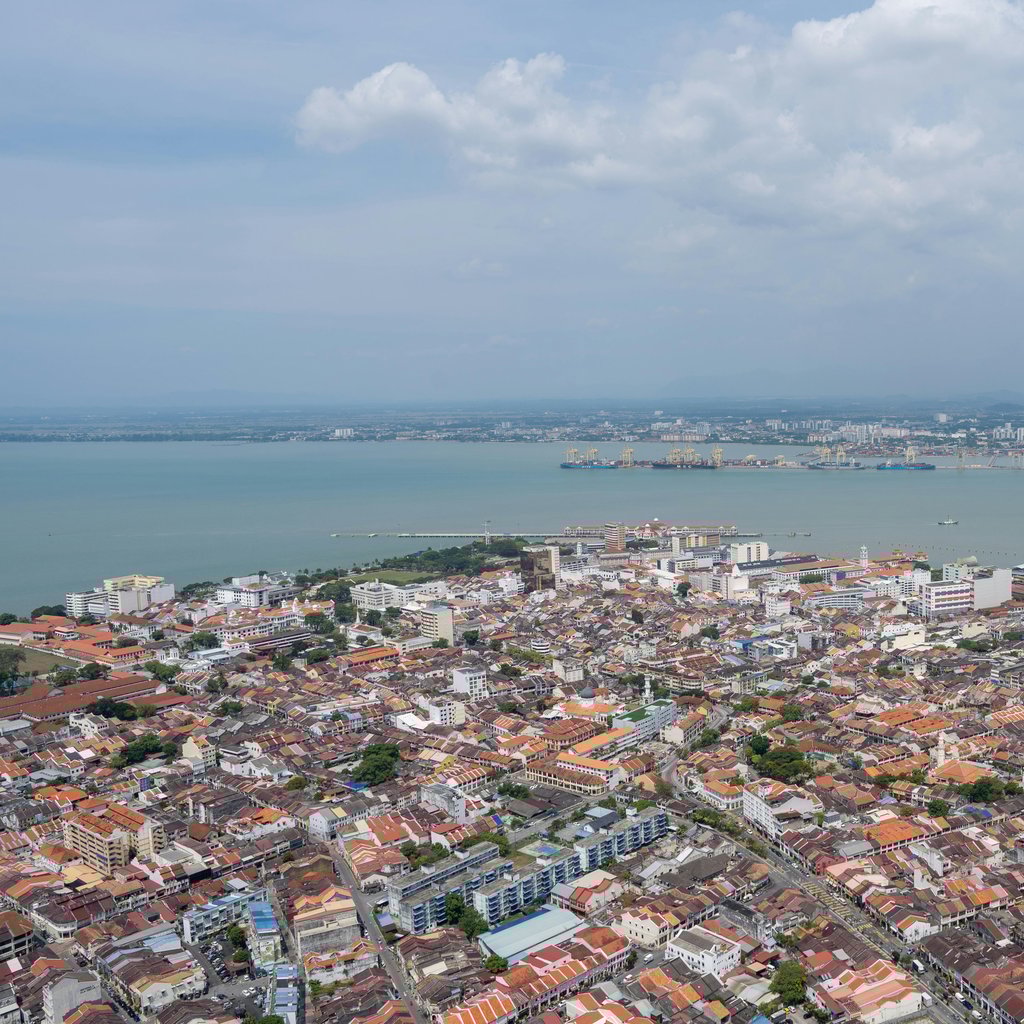 A breathtaking aerial view of Georgetown, Penang highlighting the urban landscape and coastline.