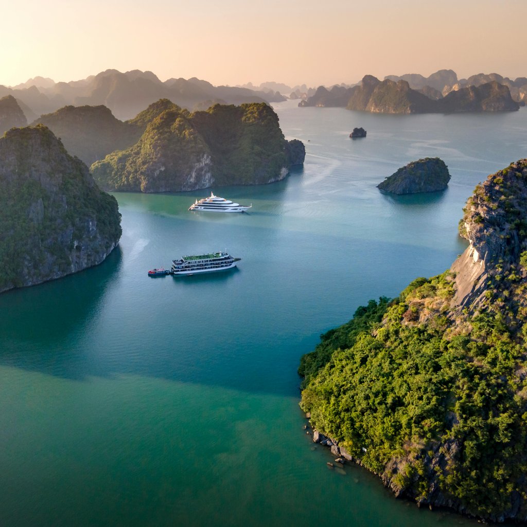 Stunning aerial view of cruise ships navigating the scenic Halong Bay in Vietnam.