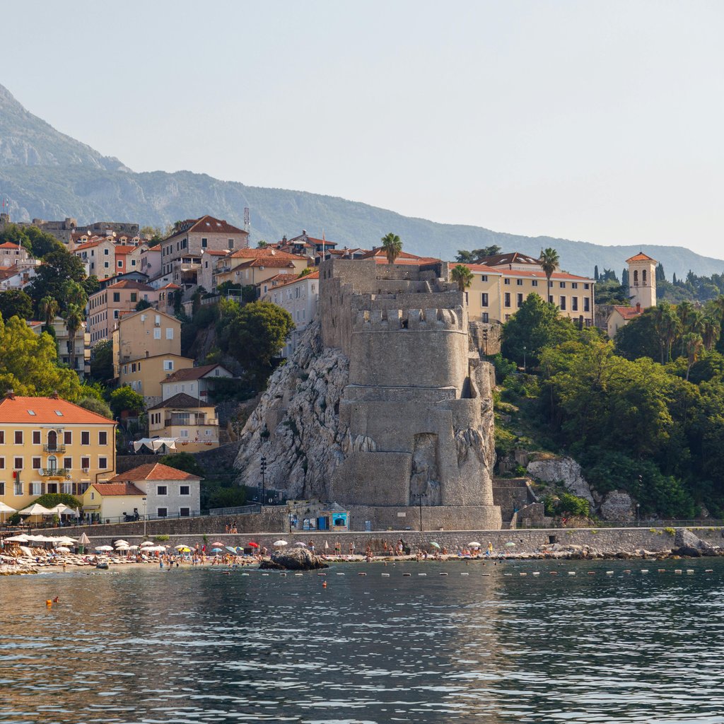 Explore the stunning coastal view of Herceg Novi, Montenegro with the historic Kanli Kula tower by the Adriatic Sea.