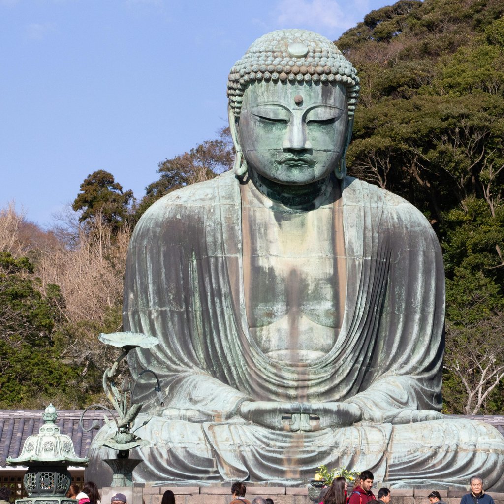 Majestic Great Buddha statue at Kotoku-in Temple, Kamakura, Japan, capturing serene ambiance in spring.