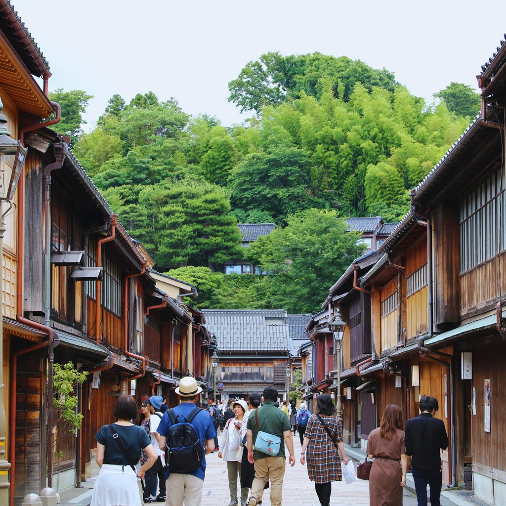 Explore the charming historic streets of Kanazawa, Japan, with traditional wooden houses.