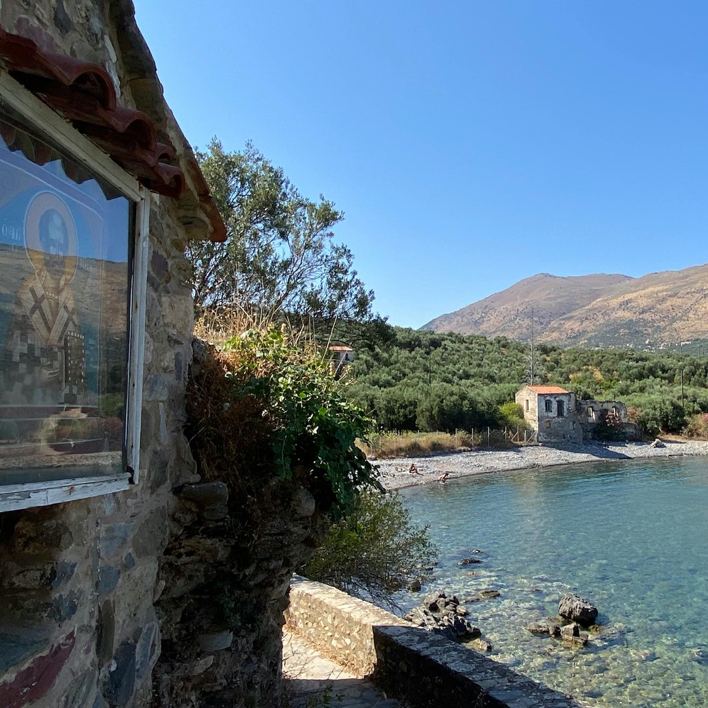 Beautiful coastal landscape of Kardamili with clear blue water and stone houses.