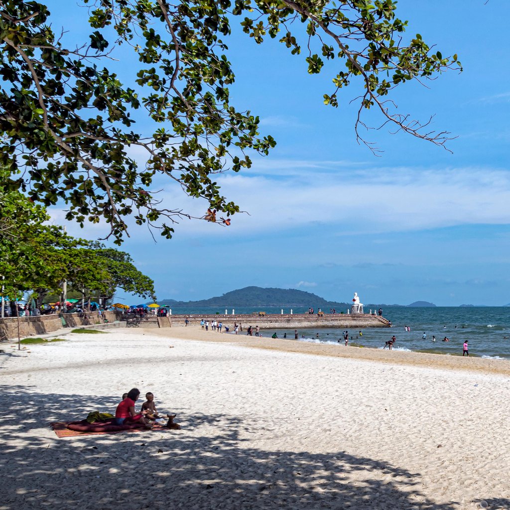 Beautiful sandy beach in Krong Kaeb, Cambodia, with people enjoying a sunny day.