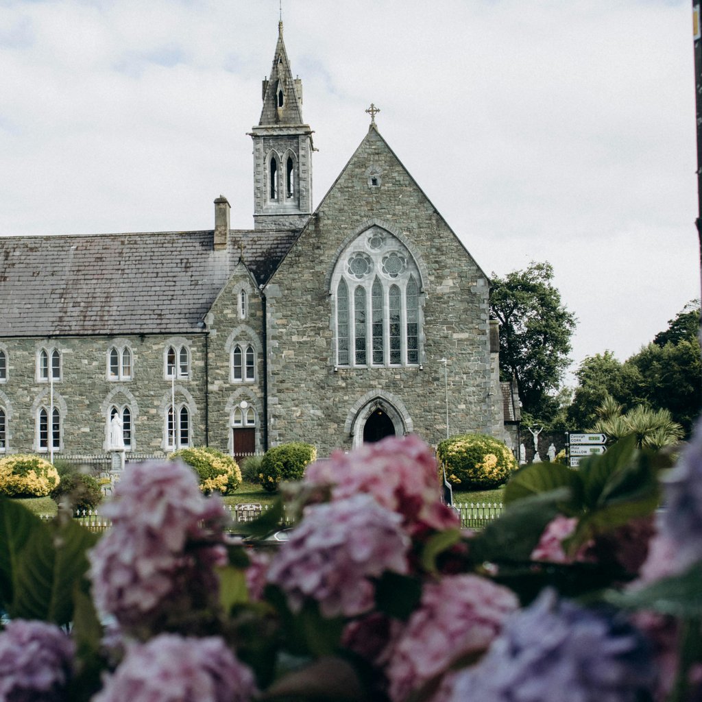Majestic medieval church with blooming flowers in Killarney, Ireland.