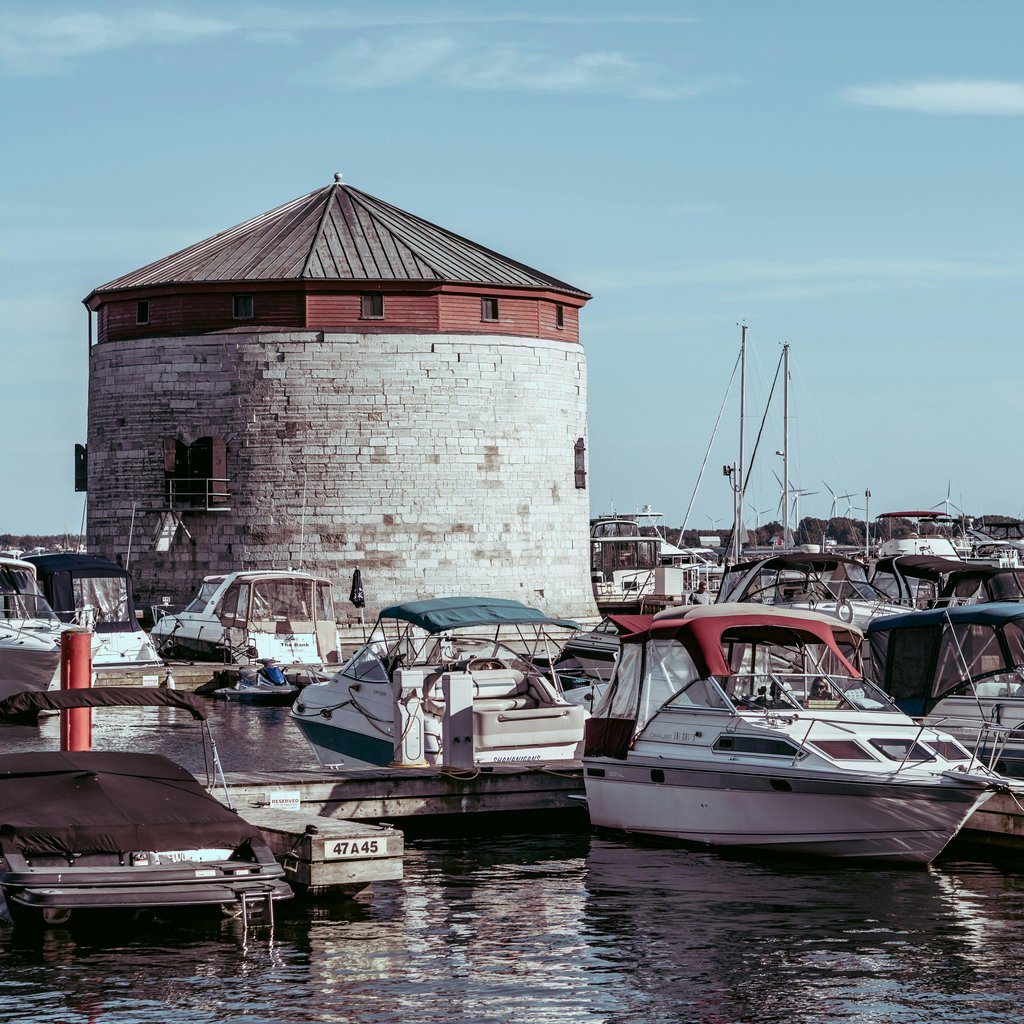 Scenic view of Shoal Tower surrounded by boats in Kingston Harbor, Ontario, Canada.