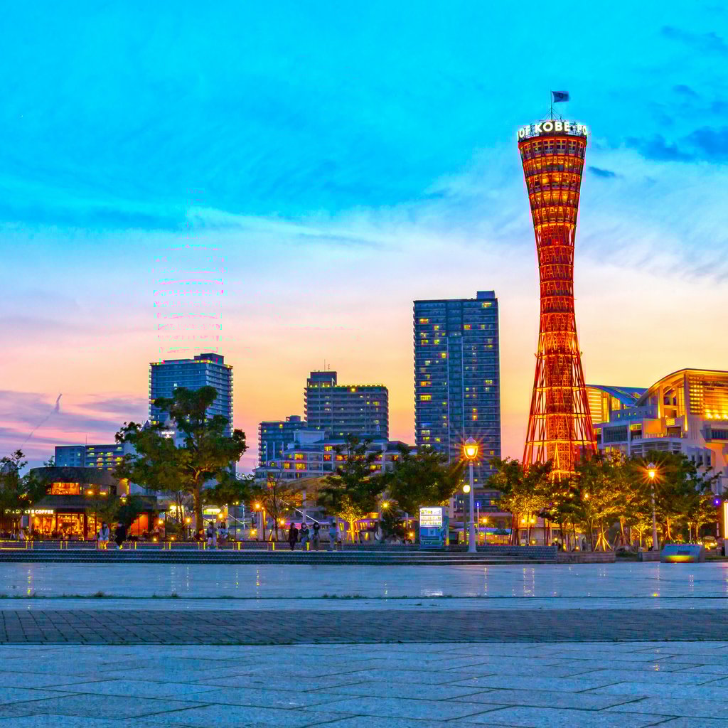 Captivating sunset view of Kobe Port Tower with vibrant cityscape in Japan.