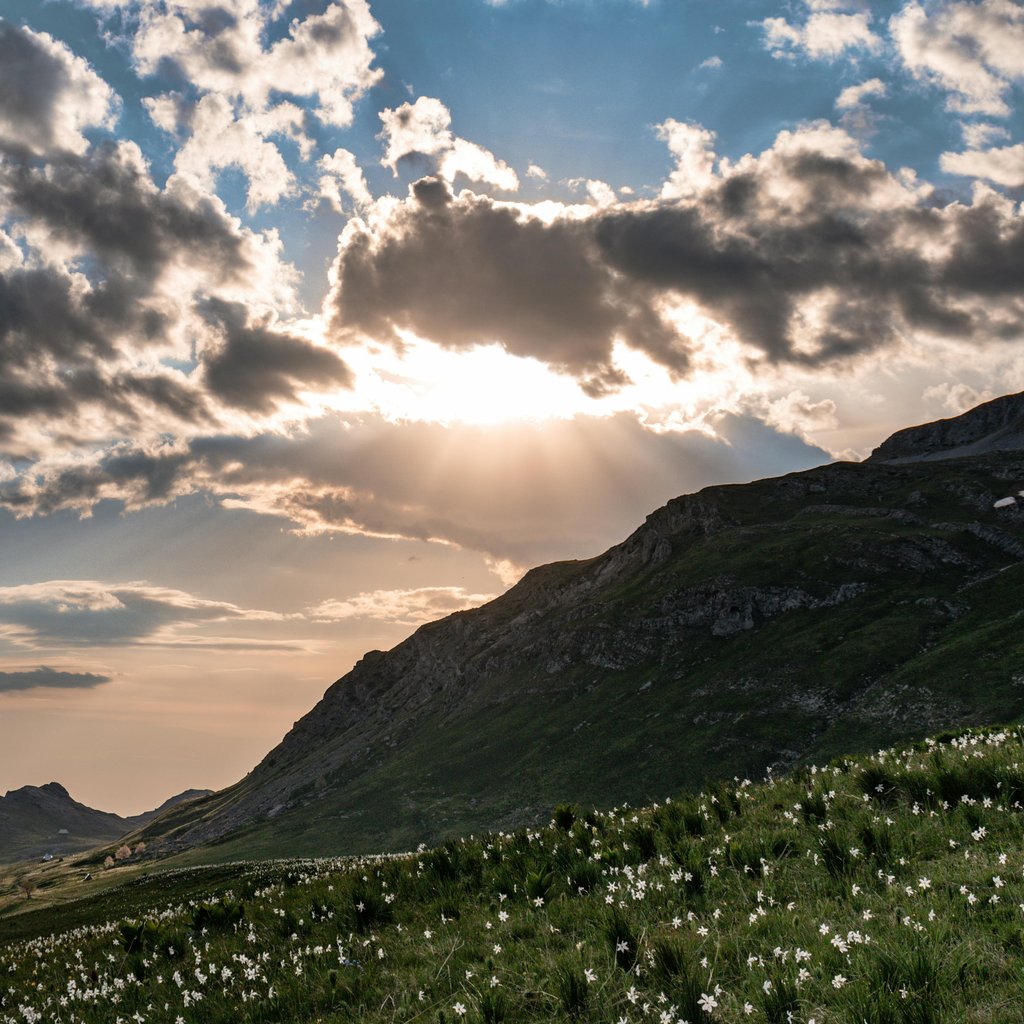 Beautiful mountainous landscape in Opština Kolašin, Montenegro, with clouds and sunset rays creating a dramatic sky.