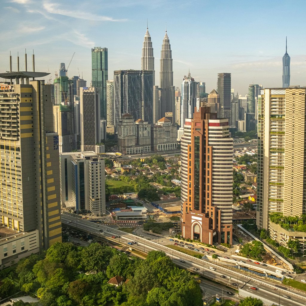 A breathtaking aerial view of Kuala Lumpur's skyline featuring the iconic Petronas Towers.