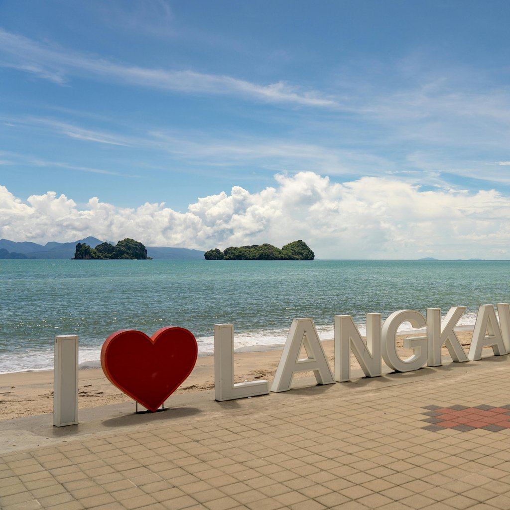 Sunny day at Langkawi beach, featuring iconic I Love Langkawi sign and stunning seascape.