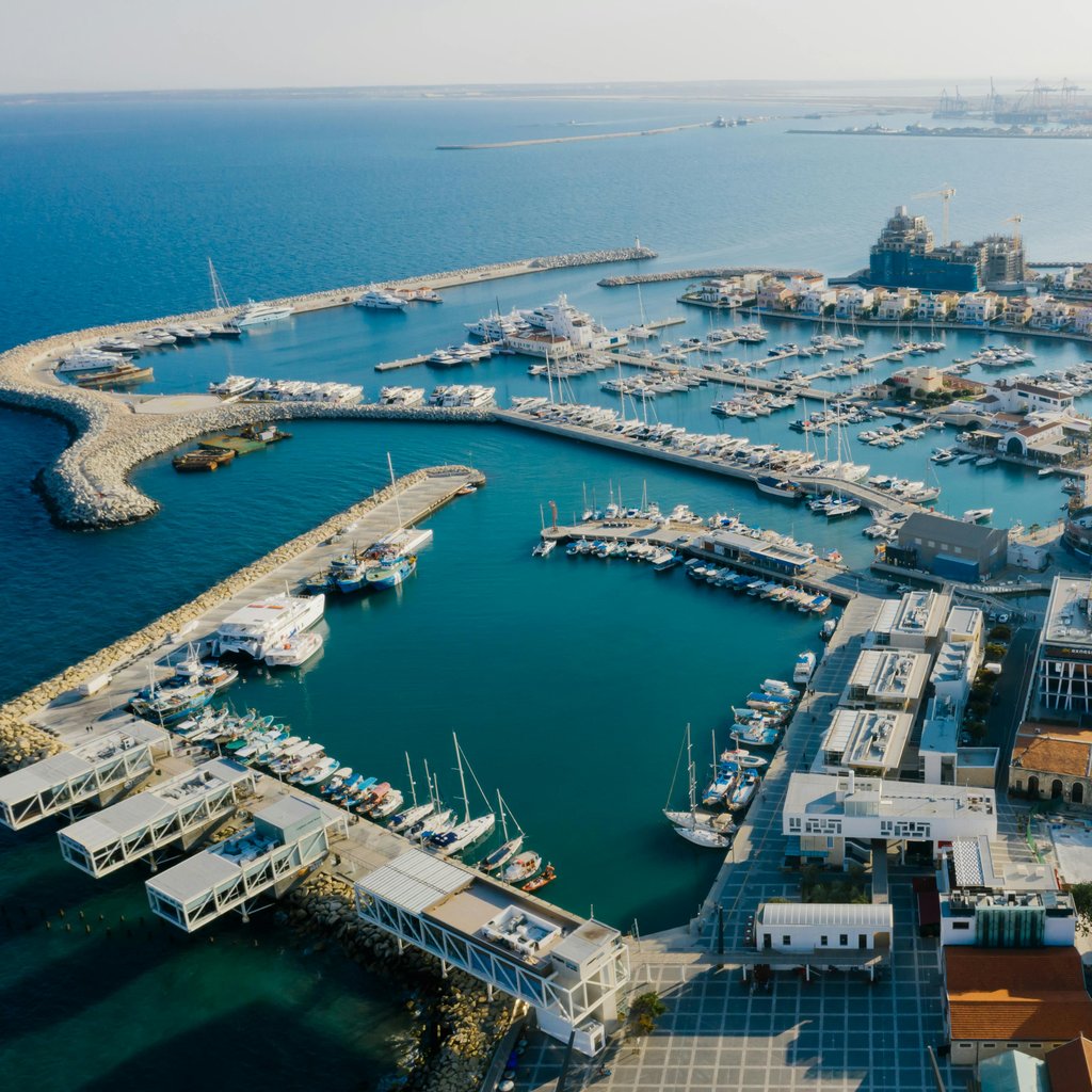 Stunning aerial view of Limassol Marina, Cyprus featuring yachts and urban landscape.