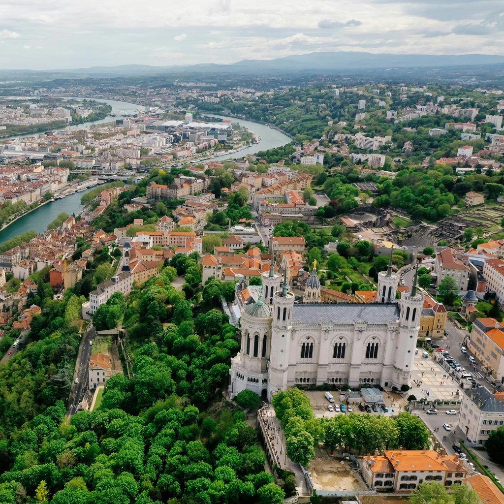 A stunning aerial view of Lyon showcasing the Basilica of Notre Dame and the city's vibrant landscape.