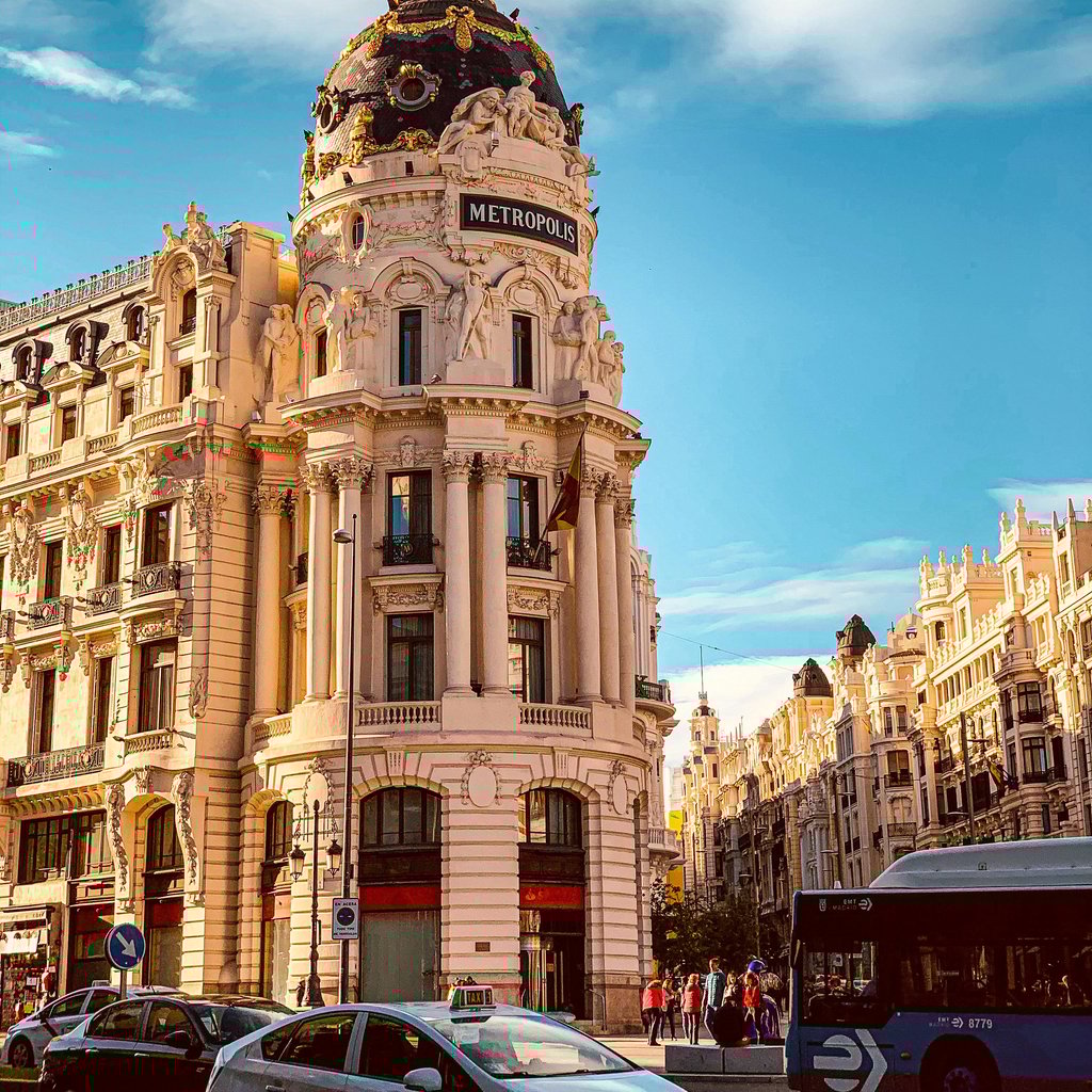 Stunning view of the iconic Metropolis building in Madrid, Spain, on a sunny day.