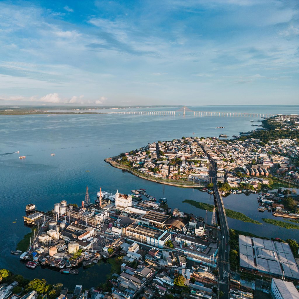 Stunning aerial view of Manaus, Brazil with Rio Negro Bridge in the distance.