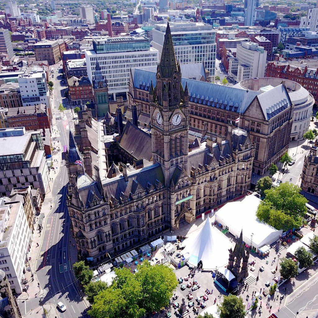 Aerial view of the iconic Manchester Town Hall and surrounding cityscape in the United Kingdom.