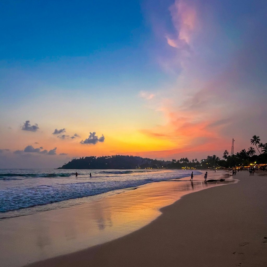 Stunning beach sunset at Mirissa, Sri Lanka, with colorful skies and serene waters.