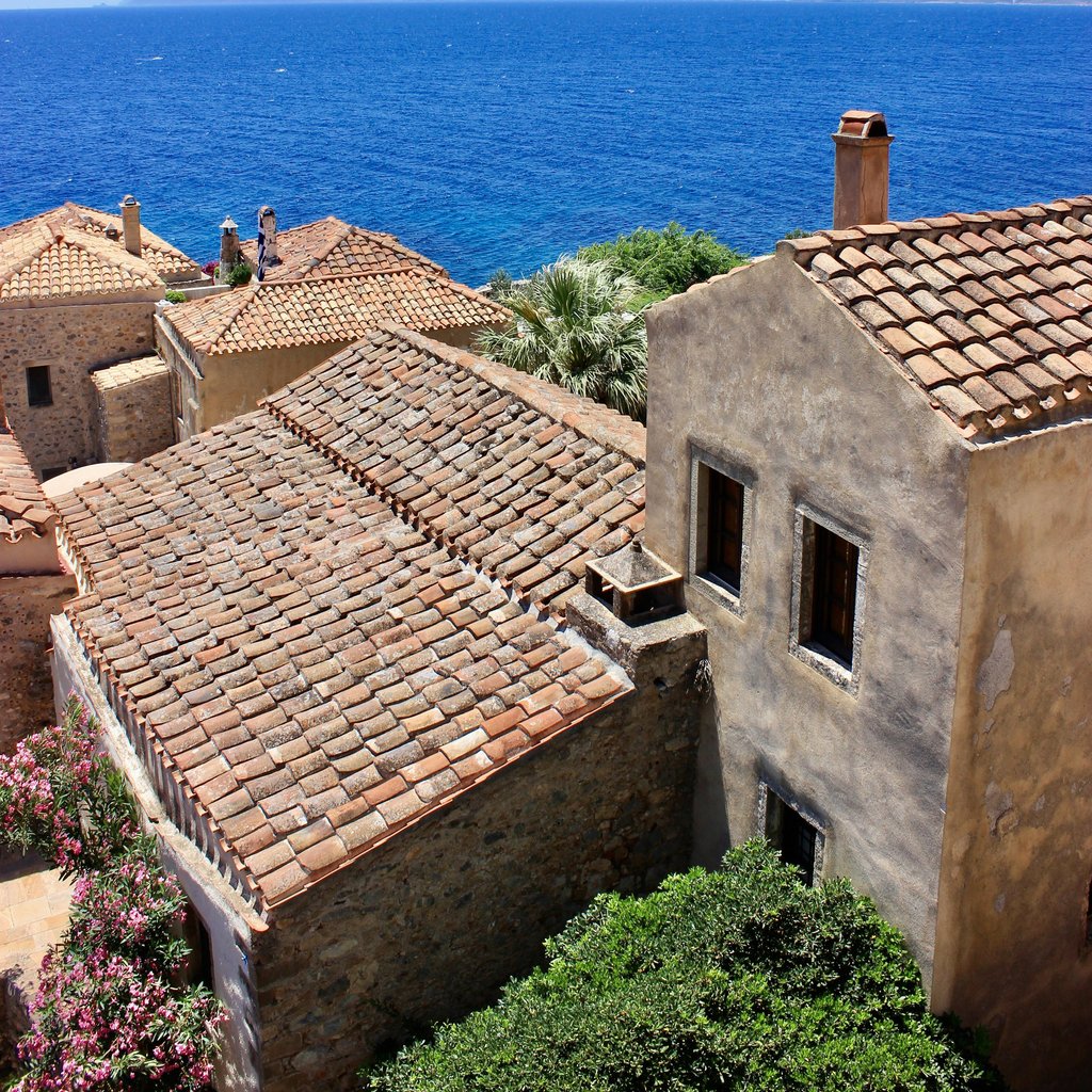 A stunning aerial view of Monemvasia, Greece, showcasing historic architecture and the deep blue sea.
