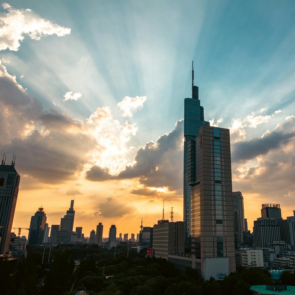 Stunning sunset over Nanjing city skyline, highlighting the Zifeng Tower.
