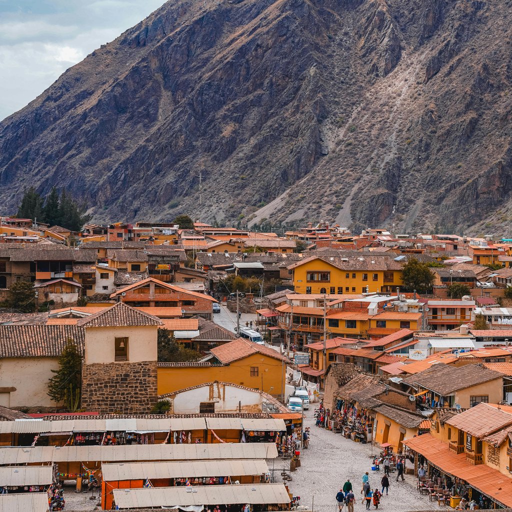 Panoramic view of the historical town Ollantaytambo nestled in the Andes mountains, Cusco, Peru.