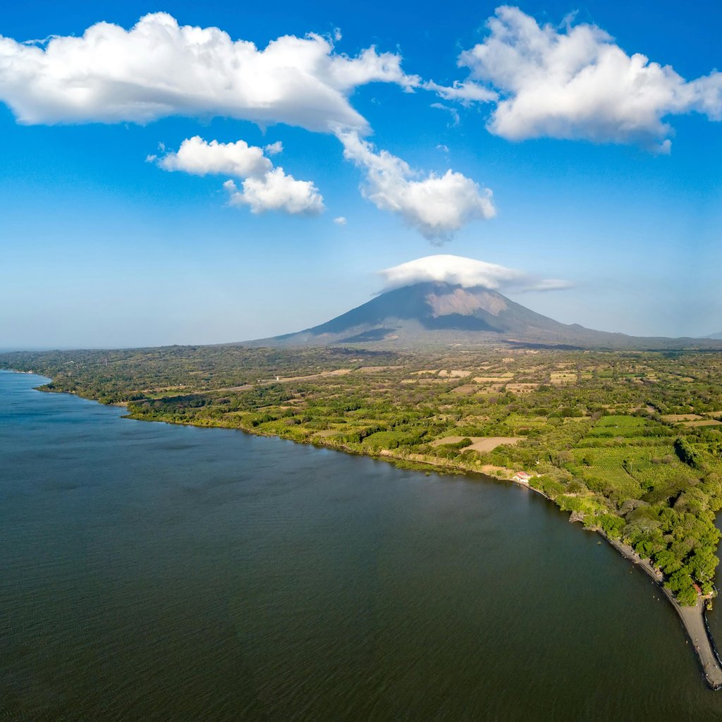Explore the stunning aerial view of Ometepe Island and its volcanic landscape surrounded by serene waters.